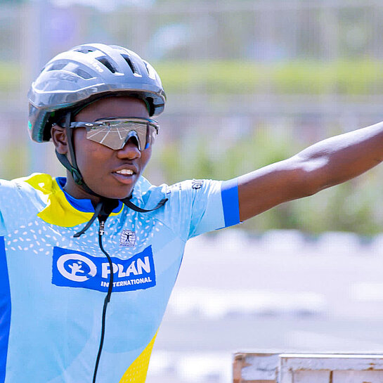 Ein Mädchen in Fahrrad-Montur freut sich über ihren Sieg als Fahrrad-Champion