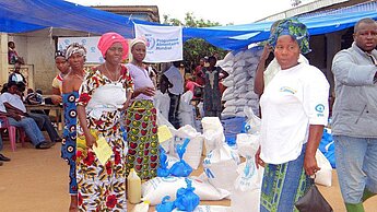 Mitarbeiterinnen und Mitarbeiter von Plan und dem WFP verteilen Rationen für 45 Tage bestehend aus Reis, Zucker, Palmöl und Erbsen.