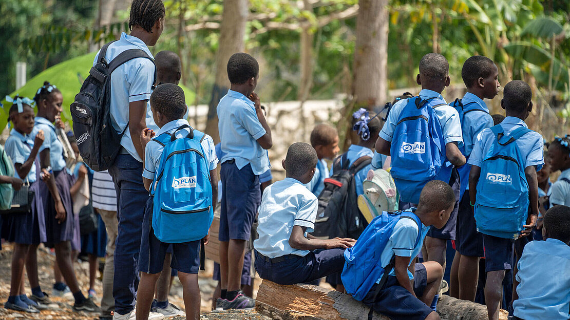 Kinder erhalten Schulsachen von Plan International