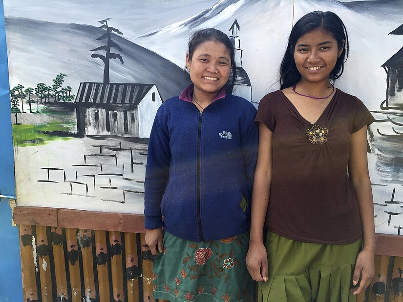 Urmila (right) and her friend stand in front of their temporary school, which currently supports the 41 children Urmila (right) and her friend stand in front of their temporary school, which currently supports the 41 children