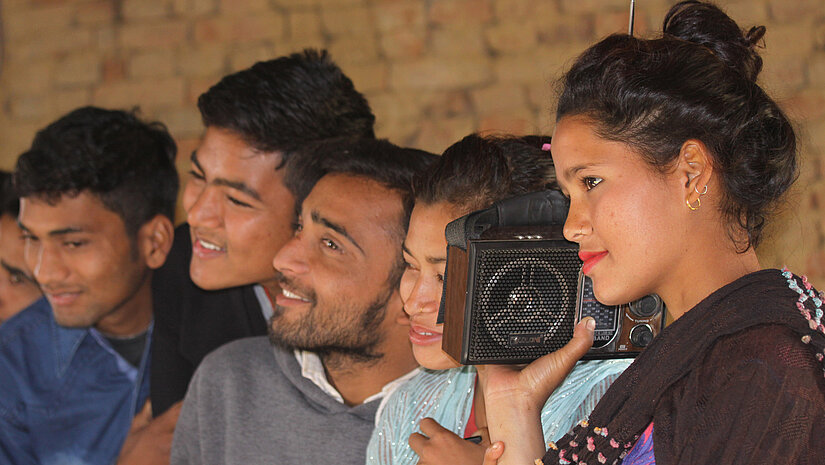 Young people listening to the radio