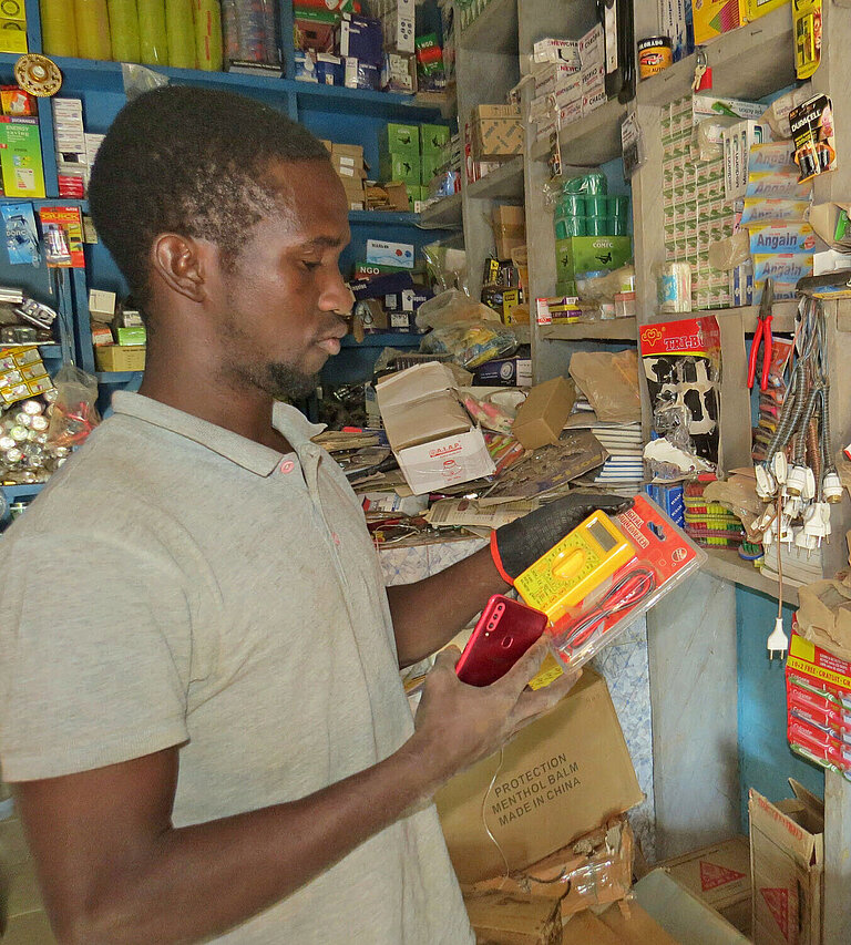 Ein junger Mann steht im Verkaufsraum eines Elektrohandels in Mali