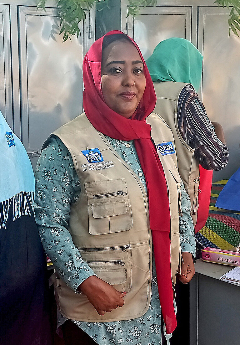Eine Frau mit dem Logo von Plan International an der Jacke