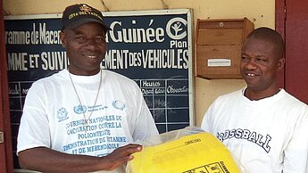 Die Plan-Teams stellen in Guinea Desinfektionsmittel, Kanister und Zerstäuber bereit.
