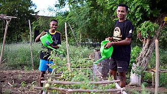 Paul und Taran bewässern Pflanzen 