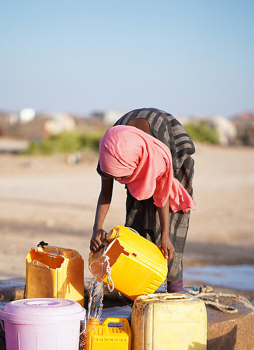 Darwaaqo füllt Wasser in Kanister.