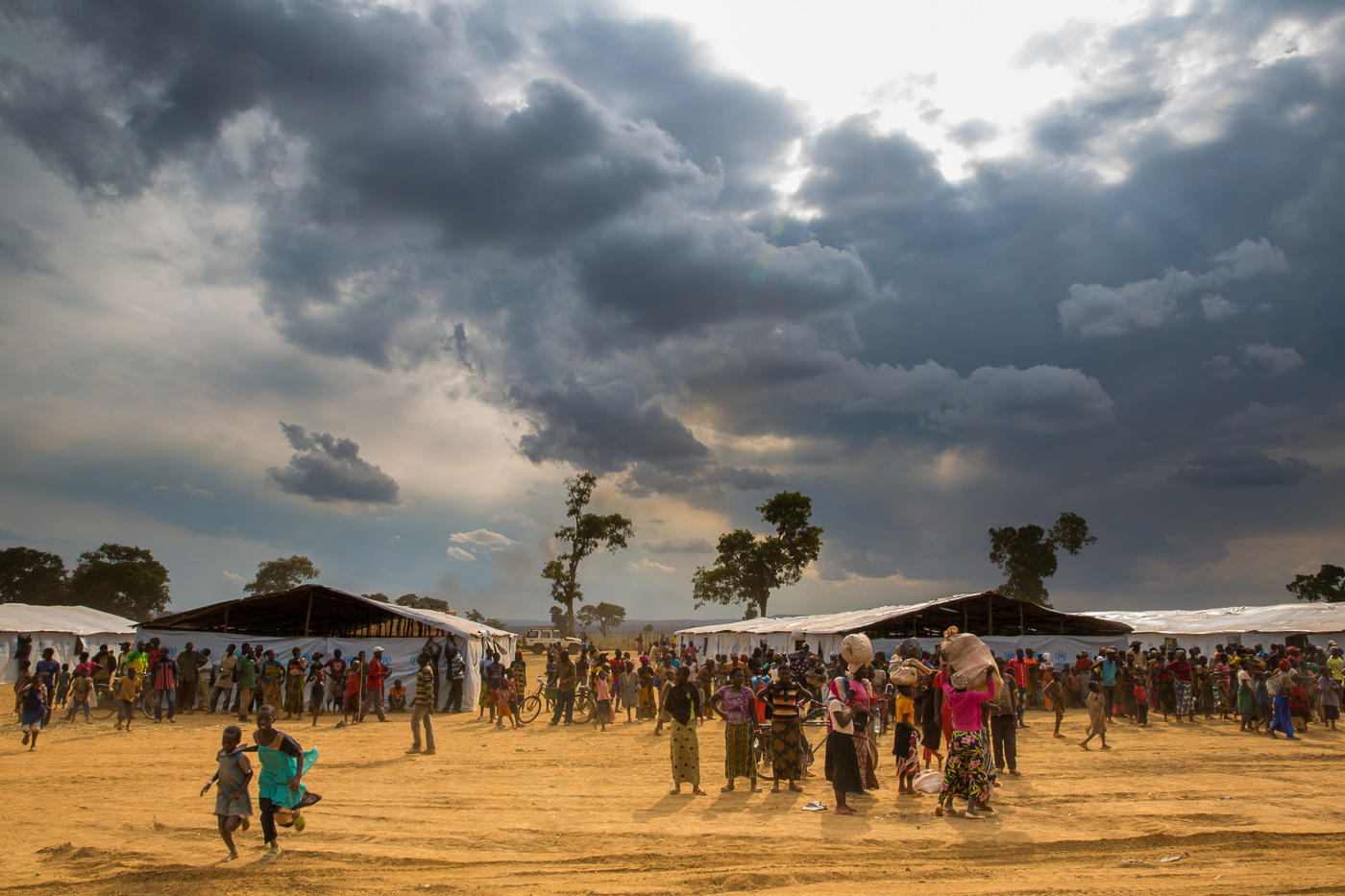 Thousands of refugees fleeing instability in Burundi are living in desperate, overcrowded conditions, at risk of disease and without shelter. At least 50,000 have amassed in the tiny village of Kagunga, to wait for boat trips to take them across Lake Tanganyika to refugee camps in Tanzania.
On arrival, they are processed at Kigoma Football Stadium, now a transit camp, before being taken to the permanent Nyarugusu camps further inland, which is already overcrowded. Plan was one of the first organisations to send field teams to Kagunga and Kigoma and is now working with the International Rescue Committee and UNICEF to set up safe spaces for children to learn and play, as well as helping them receive support and referrals for further care.